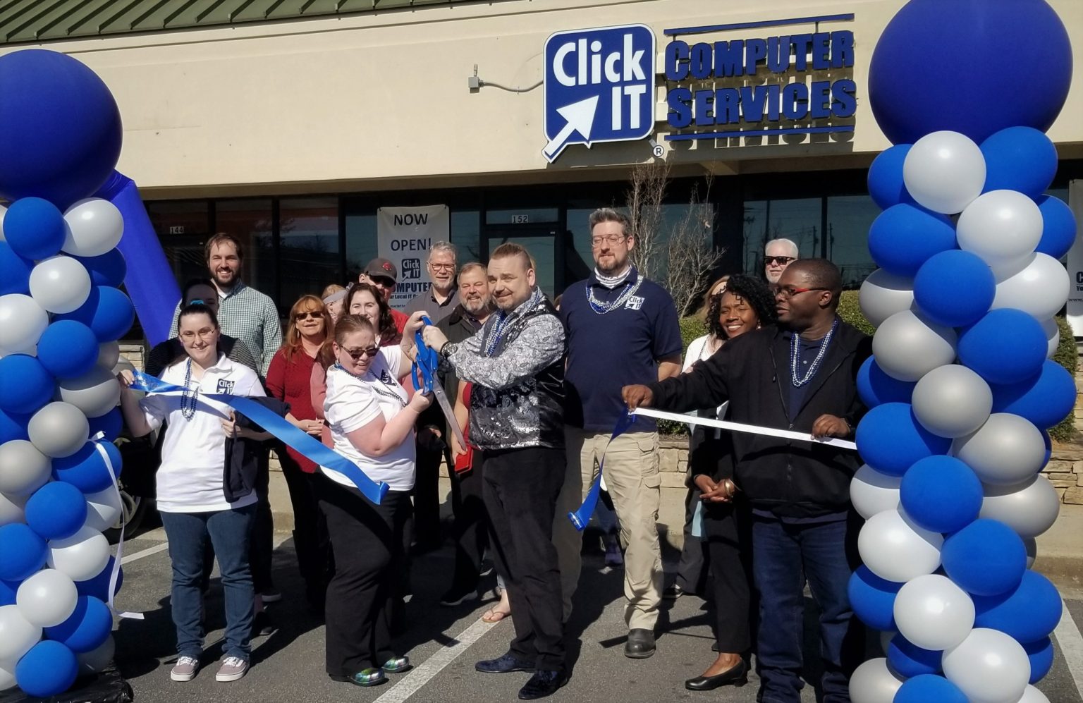 Click IT franchise owners and community leaders at a grand opening ribbon cutting