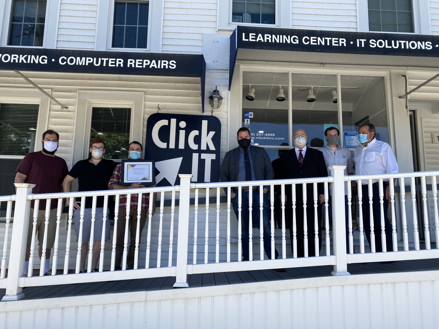 The Click IT corporate store team in front of the store